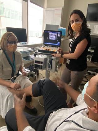 Penn Med Family Sports Medicine Fellowship  - Clinician and Fellow performing ankle ultrasound on patient